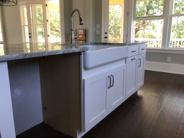 Charleston kitchen remodel with white shaker cabinets and quartz island