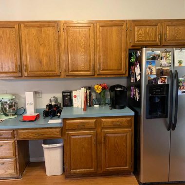 Dated oak kitchen cabinets with a built-in desk before a Charleston kitchen remodel
